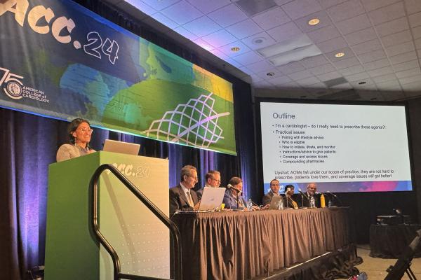 Neha Pagidipati stands at a podium presenting in front of a panel at ACC 2024. 