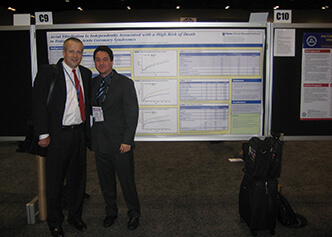 Former DCRI director Bob Harrington supports then fellow and current DCRI faculty Renato Lopes during his poster presentation at AHA 2007.