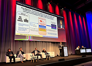 DCRI faculty member Stephen Greene stands at a podium at ESC 2024 discussing the linical and financial implications of inpatient and outpatient management strategies for worsening heart failure.