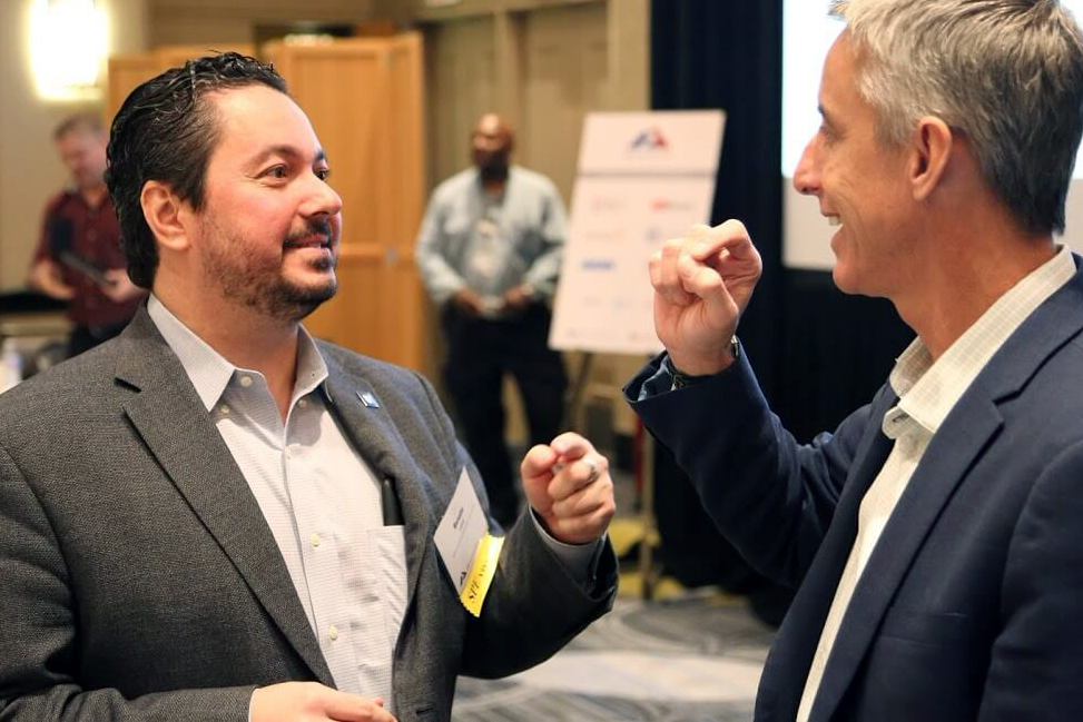 Renato Lopes (Duke) and Kenneth Mahaffey (Stanford) discuss collaboration during a CEC Summit.