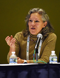 DCRI's Karen Alexander speaks expressively at the 2024 AHA Scientific Sessions while seated at a table of panelists.