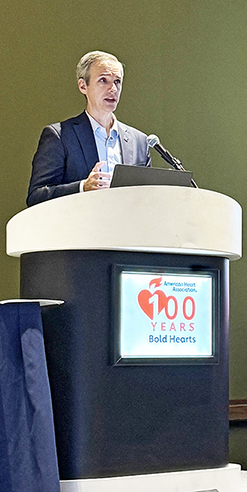 DCRI's Schyuler Jones speaks at a podium at the 2024 AHA Scientific Sessions.