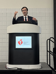 Marat Fudim stands at a podium presenting at AHA25