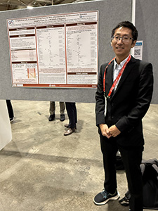 Satoshi Shoji stands proudly by his poster at AHA25