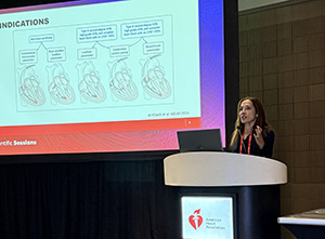 Svati Shah stands at a podium presenting her insights during AHA25