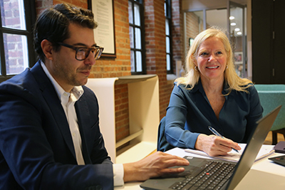 i-Cubed leaders Mickey Cohen-Wolkowiez and Donna Parker discuss their next project while sitting at a table.