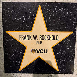 Star-shaped floor plaque displaying the text “FRANK W. ROCKHOLD, PH.D.” and the VCU logo.