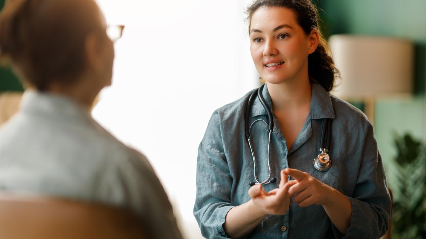 Female patient and a doctor talking in hospital.