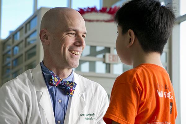 DCRI faculty member Danny Benjamin speaks with a pediatric patient.