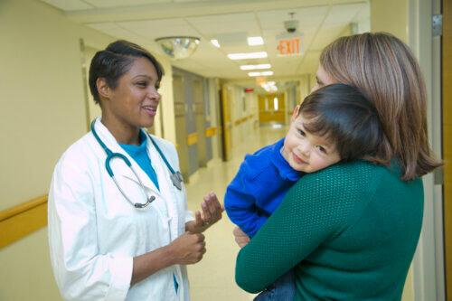 Dr. Kanecia Zimmerman speaking to a mother and son