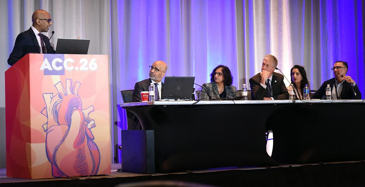 DCRI’s Sreekanth Vemulapalli, MD, stands at a podium presenting the results of the ADAPT-CEC study, while five panelists look on.