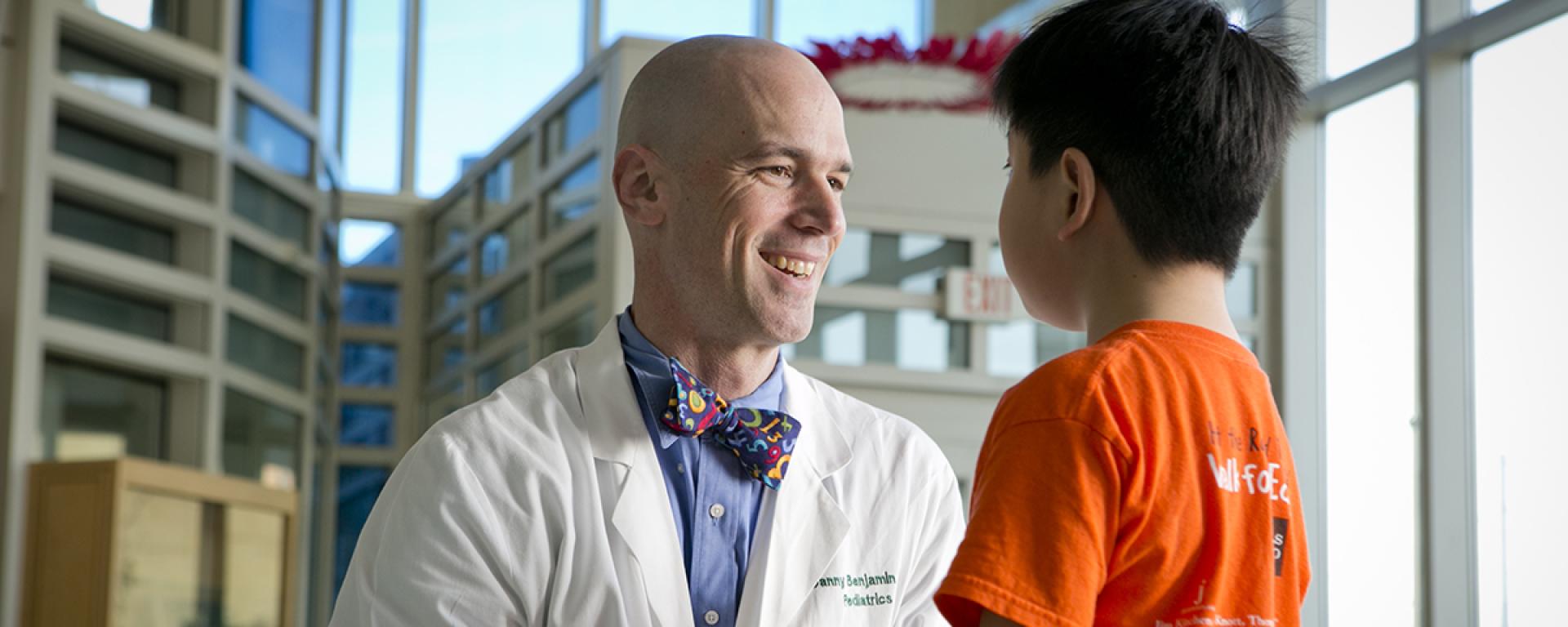 Dr. Danny Benjamin smiles as he speaks with a pediatric patient at the Duke Children's Hospital.