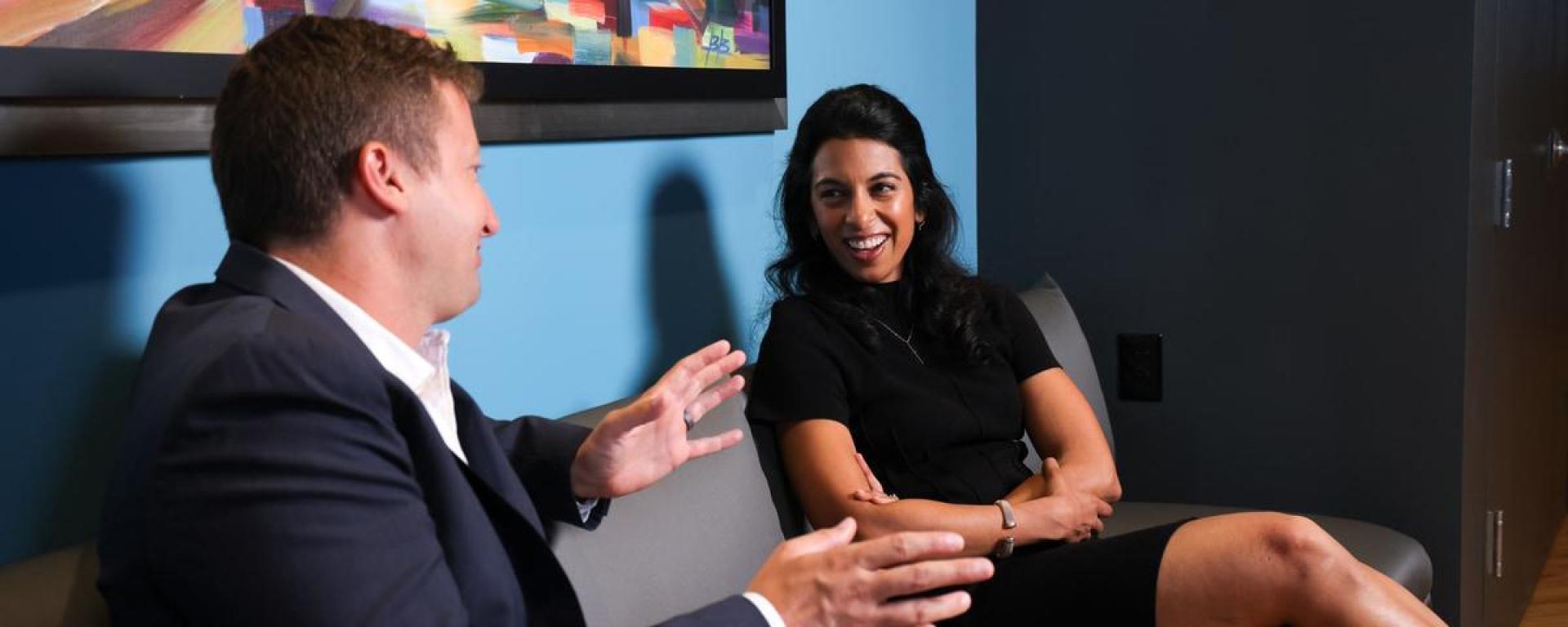 two people sitting and talking
